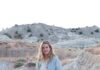 Shop Local: This Week’s Cozy Products from New Mexico Shops and Makers A woman in a long blue cardigan in a dessert.